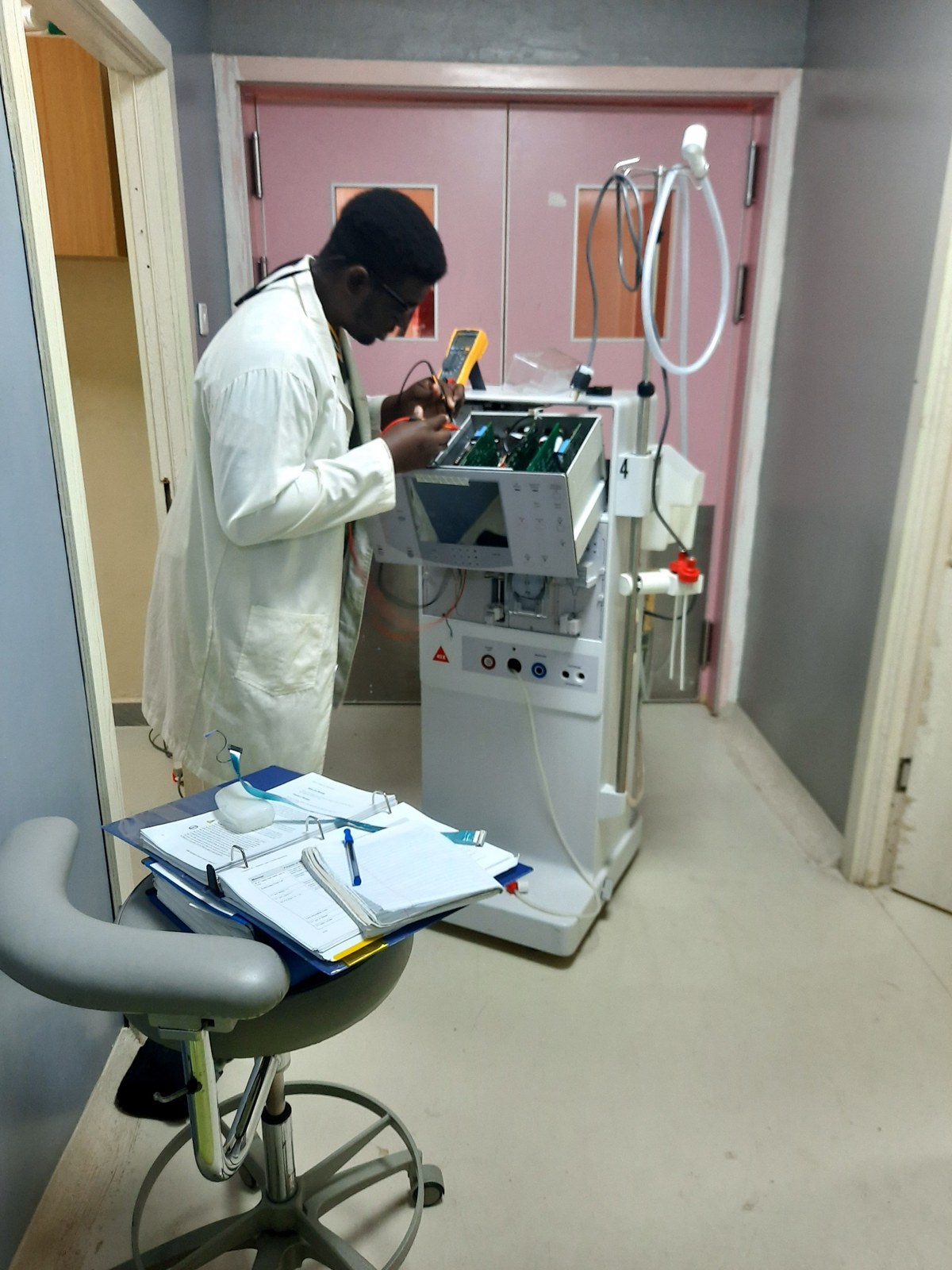 Biomedical engineer performing medical equipment lifecycle support and troubleshooting
